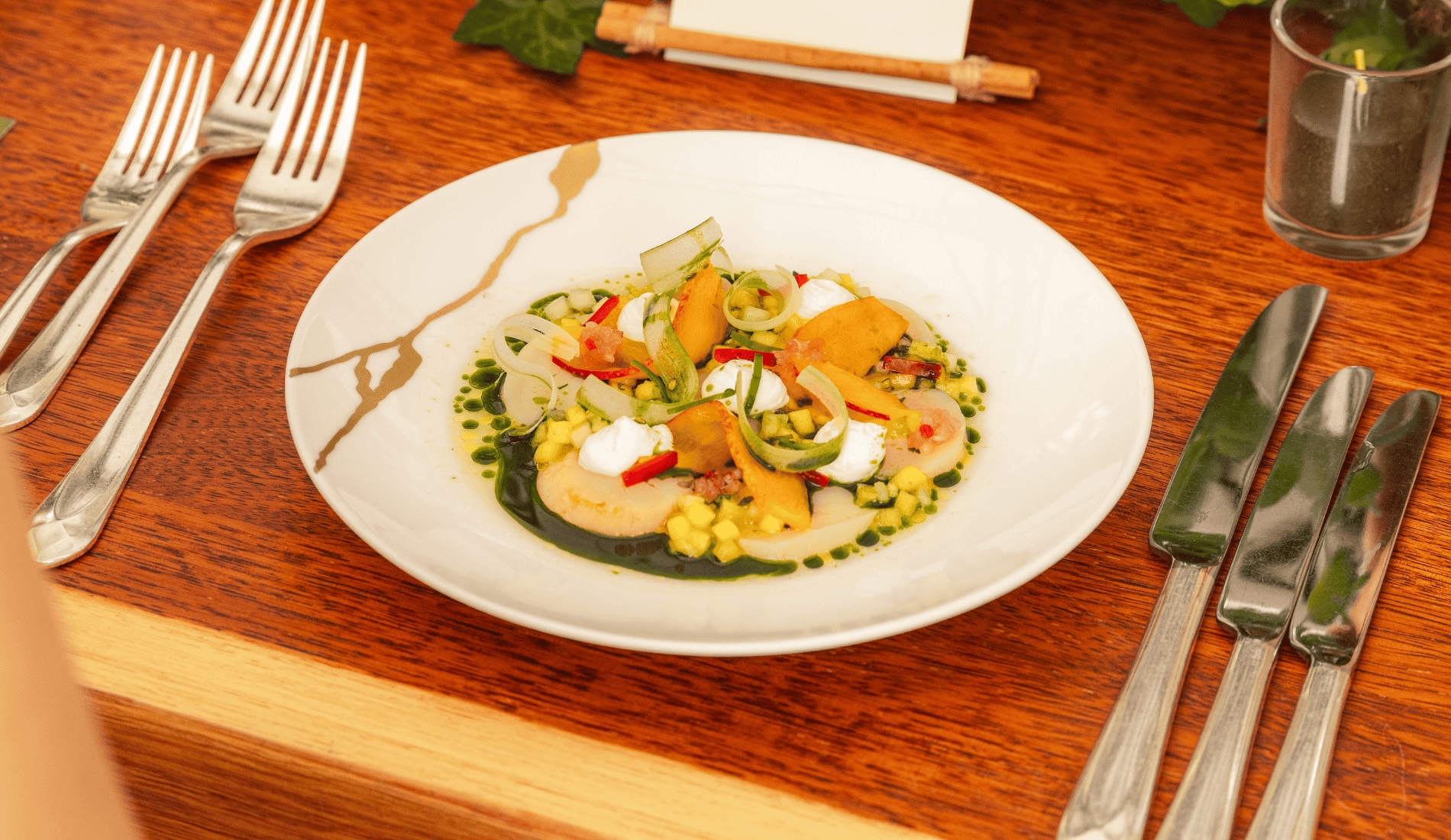 White plate with Scallop Ceviche on a wood table
