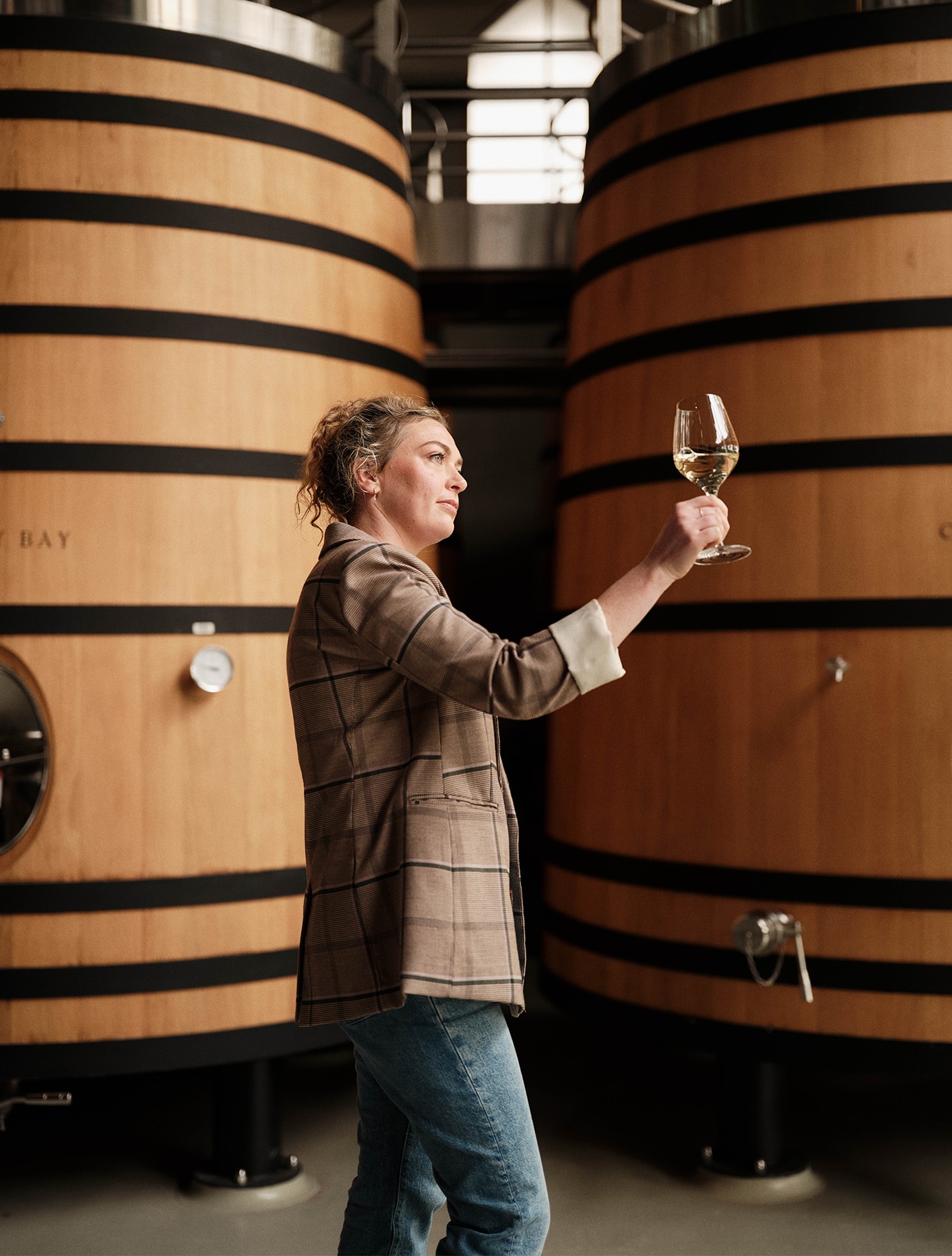 Kelly looking at the wine in a glass